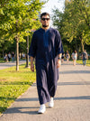Man wearing a half-sleeve Moroccan thobe with sfifa embroidery, styled for summer - Furqanwear
