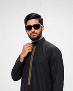 Muslim man wearing black and gold Saudi thobe for Eid and Nikah occasions — Furqanwear