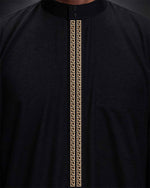 Close-up of gold embroidery on black Saudi thobe collar and placket — Furqanwear