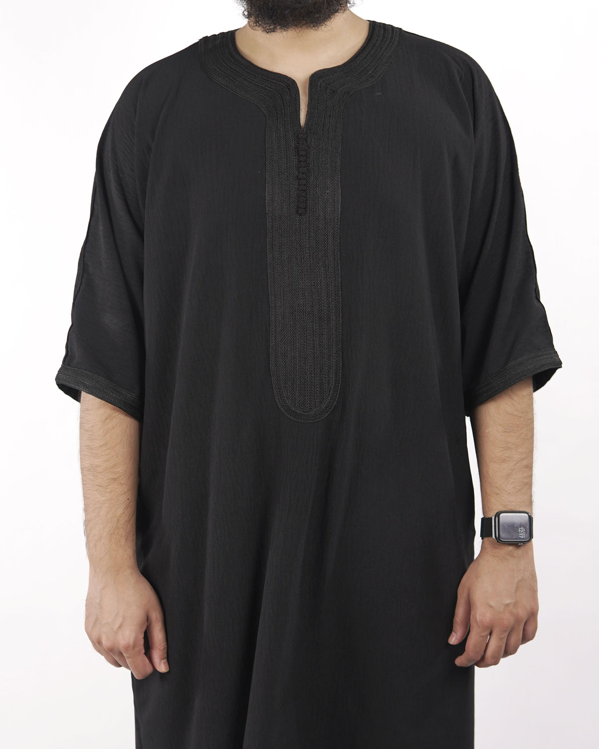 Close-up detail of the intricate traditional embroidery on the neckline and chest of a black half sleeve Moroccan thobe.