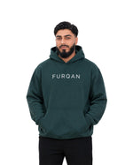 Back of forest green Furqanwear Islamic hoodie with the From Him To Him print, worn by a man