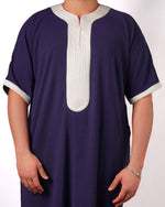 Close-up of the contrast light grey trim on the neckline, placket, and short sleeve cuffs of a men's navy blue thobe.