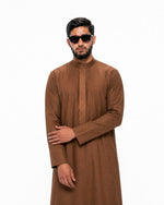 close view of copper brown Saudi thobe showing clean straight cut and precise cuffs — Furqanwear