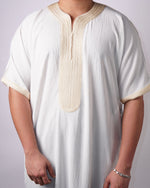 Close-up view highlighting the intricate gold embroidery on the neckline, placket, and sleeve cuffs of a men's white short-sleeve thobe.