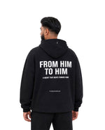 Back of black Furqanwear Islamic hoodie, worn by a man