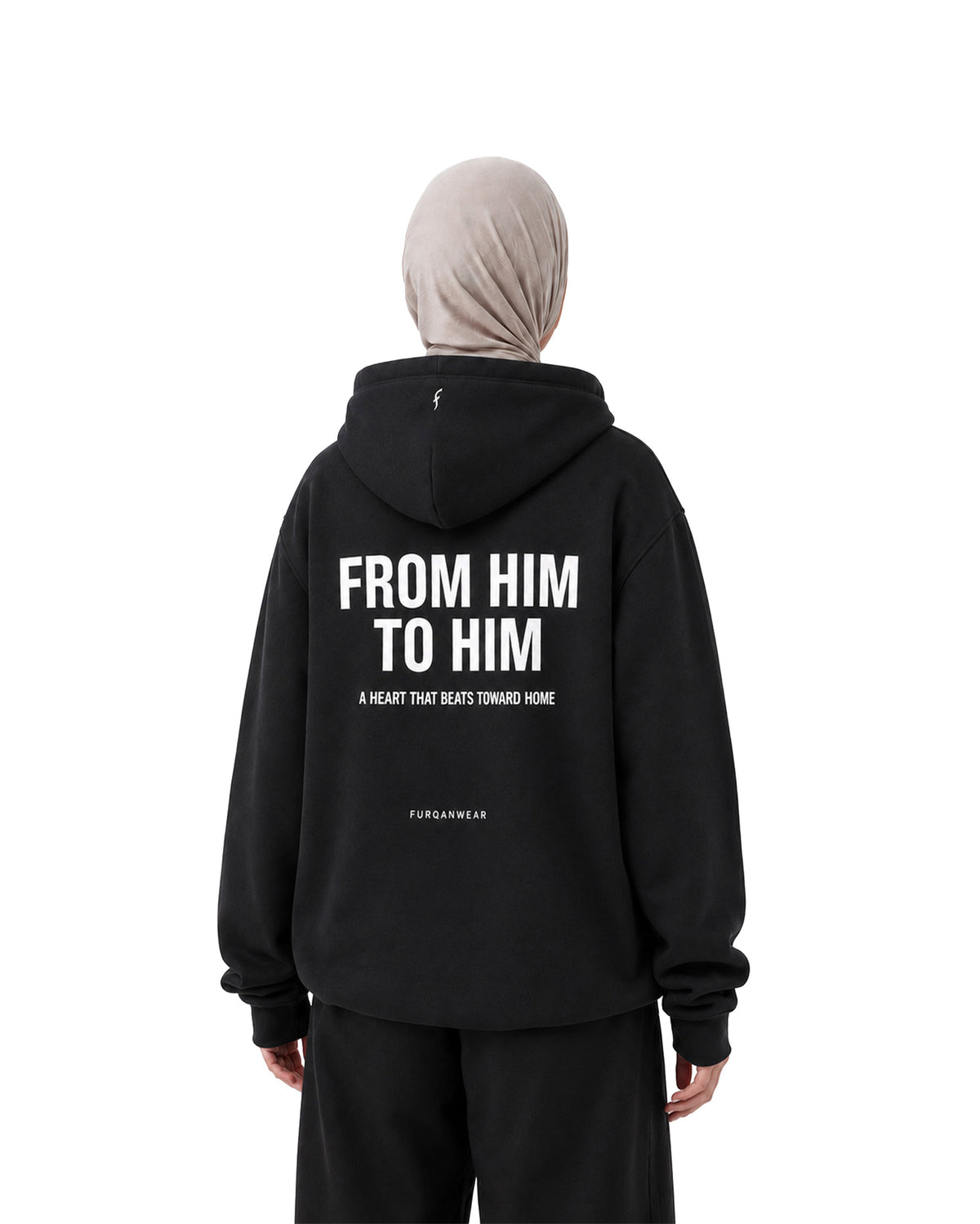 Woman in hijab showing the From Him To Him back print on a black Furqanwear Islamic hoodie