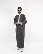 Front view of the Royal Thobe in charcoal, showcasing the white trim detail; a premium mens thobe jubba and muslim dress for men.