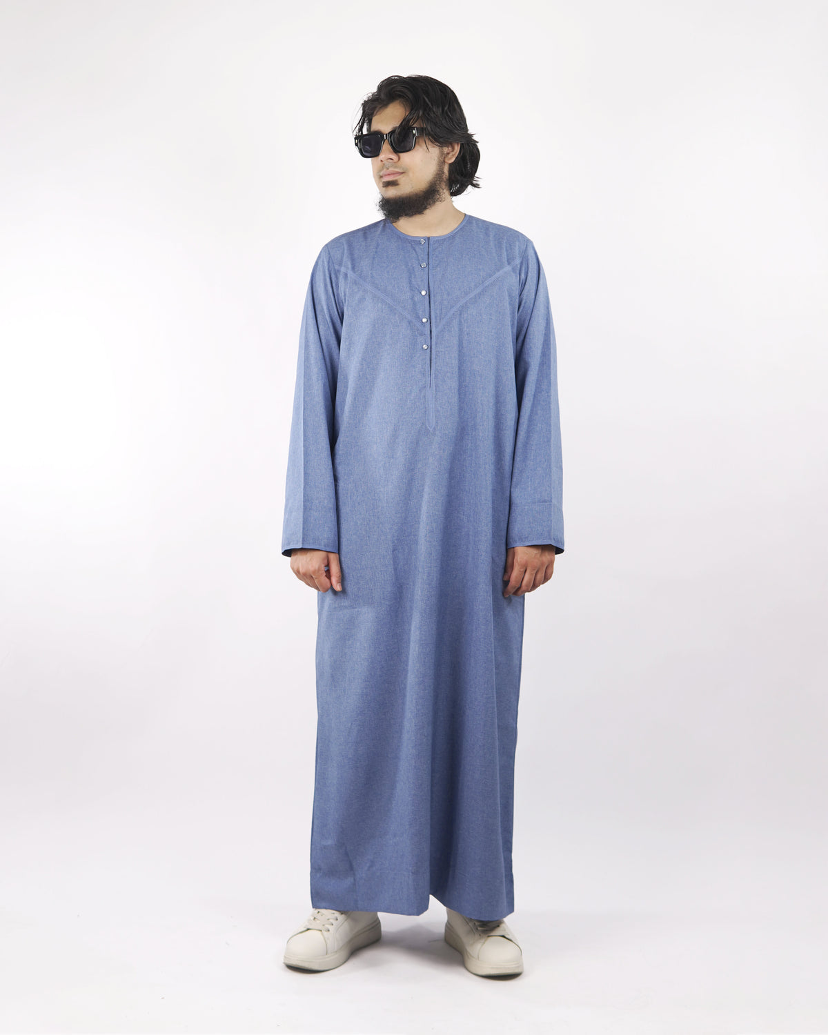 Man models a light blue classic thobe from a slight angle, showcasing this mens thobe jubba as elegant islamic clothing for men.