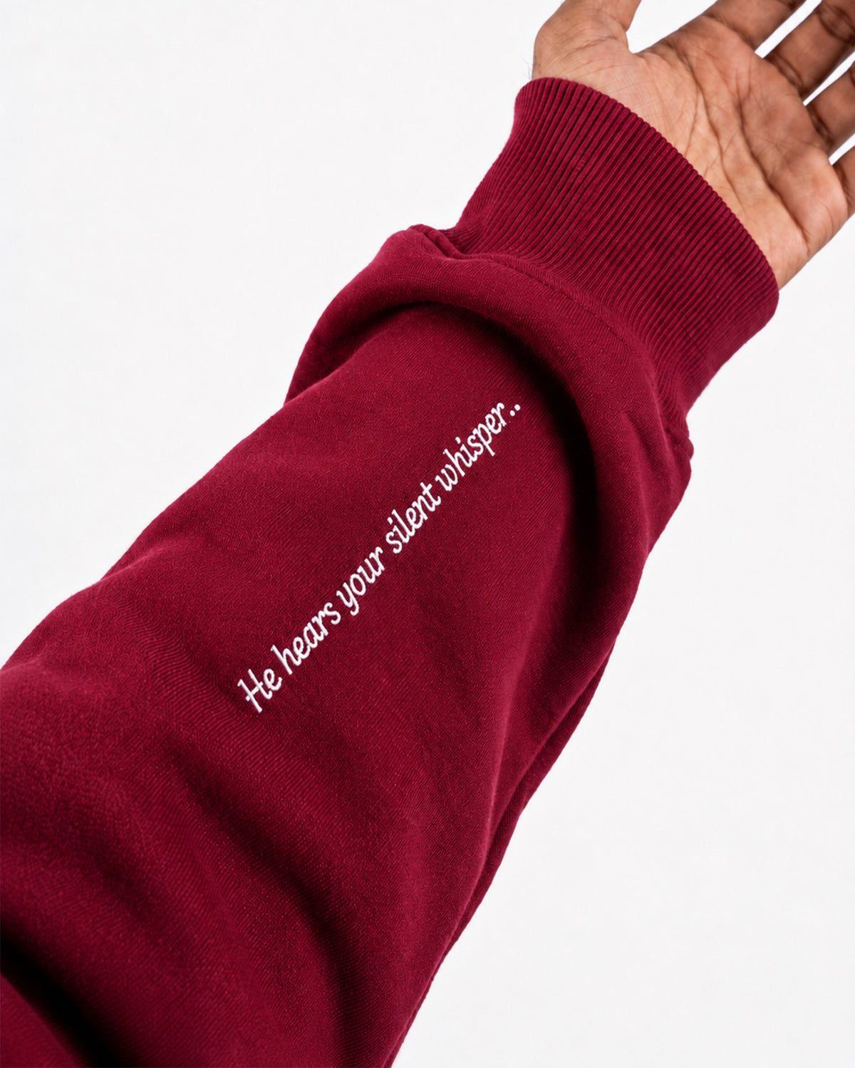 Sleeve of maroon Furqanwear Islamic hoodie printed with He hears your silent whisper