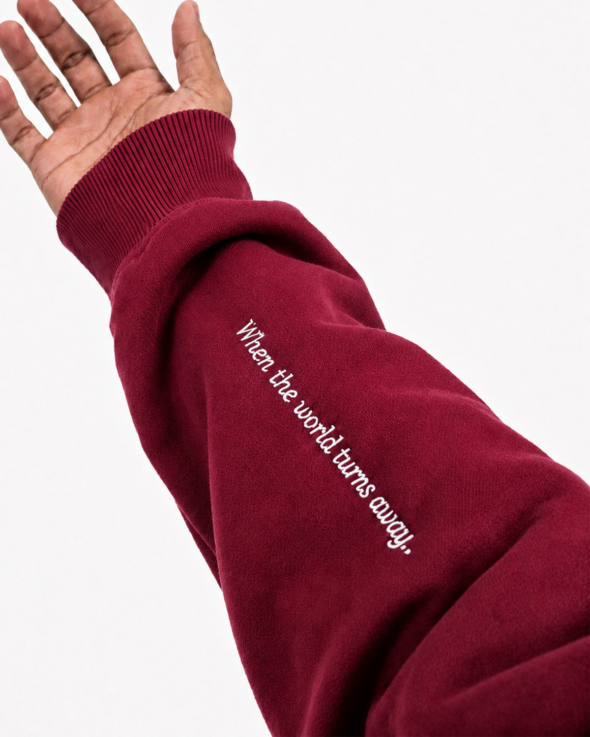 Sleeve of maroon Furqanwear Islamic hoodie printed with When the world turns away