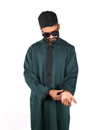 Model wearing a men's hooded green thobe with black trim, showing upper body view and adjusting the cuff.