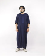 Front view of a man modeling an elegant navy blue embroidered Moroccan thobe, an ideal choice for sophisticated Muslim male wear.