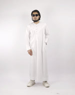 Front view of a man wearing a crisp white classic men's thobe jubba, an elegant example of Muslim dress for men suitable for various occasions.
