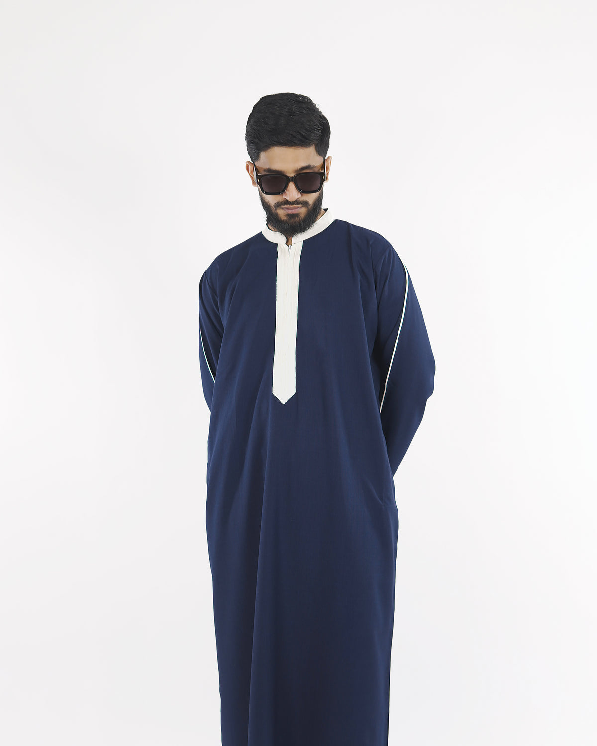The midnight navy Royal Thobe highlighting its contrasting white piping detail, a sophisticated choice for muslim dress for men.