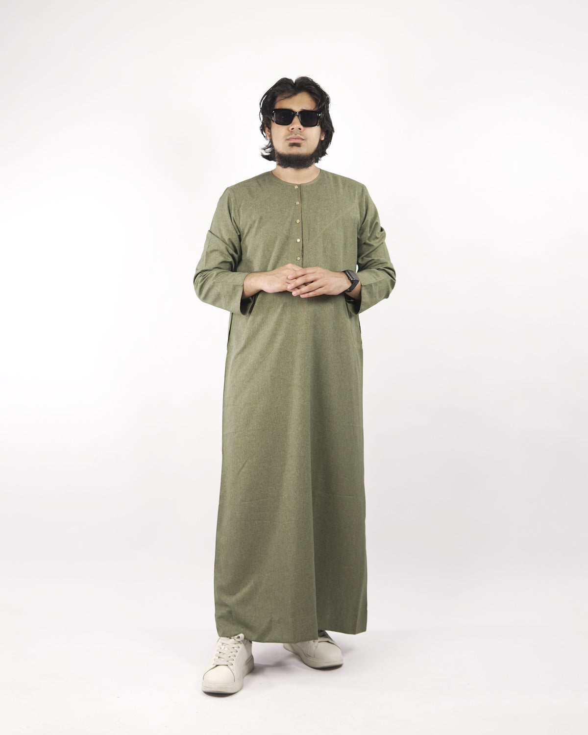 Model wears a sea green classic thobe, shown full length from the front, a fine example of islamic attire for men.